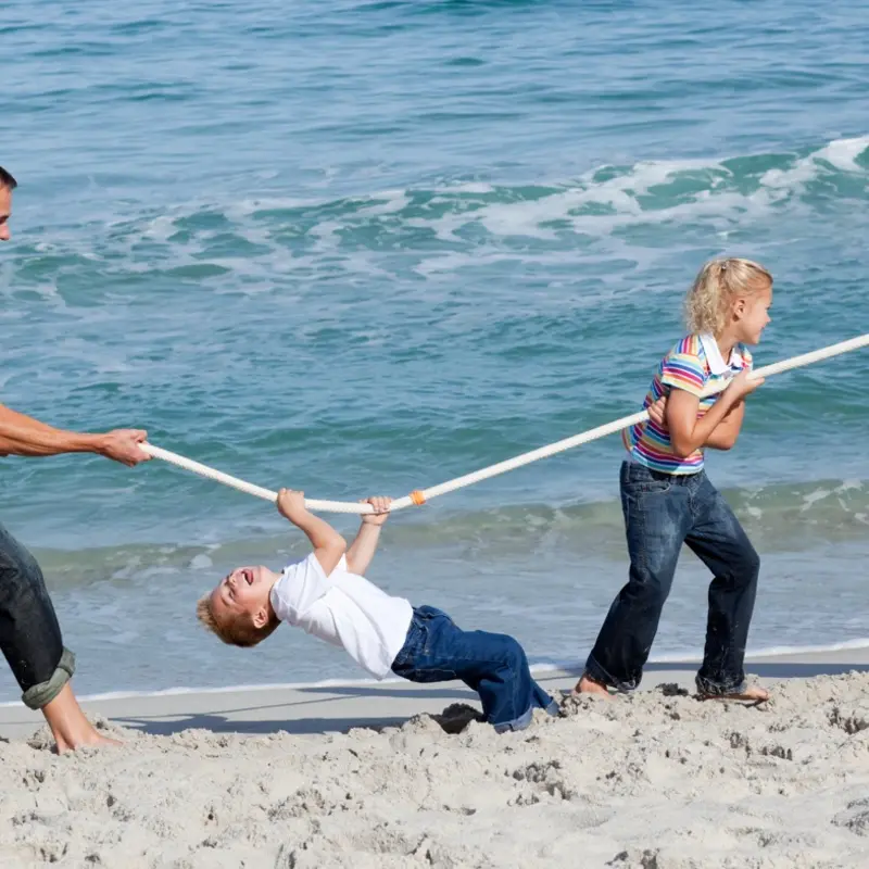 Family playing together and having a bonding experience in Rethymno Beach part of Filiko Tours Beach Games Activity