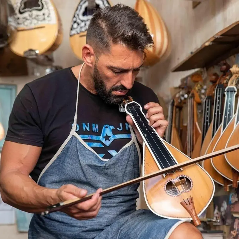 traditional Cretan lyra artisan from arts and crafts filiko tours